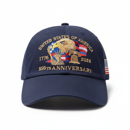 Navy blue cap with 'United States of America 1776-2026 250th Anniversary' design on a chair.