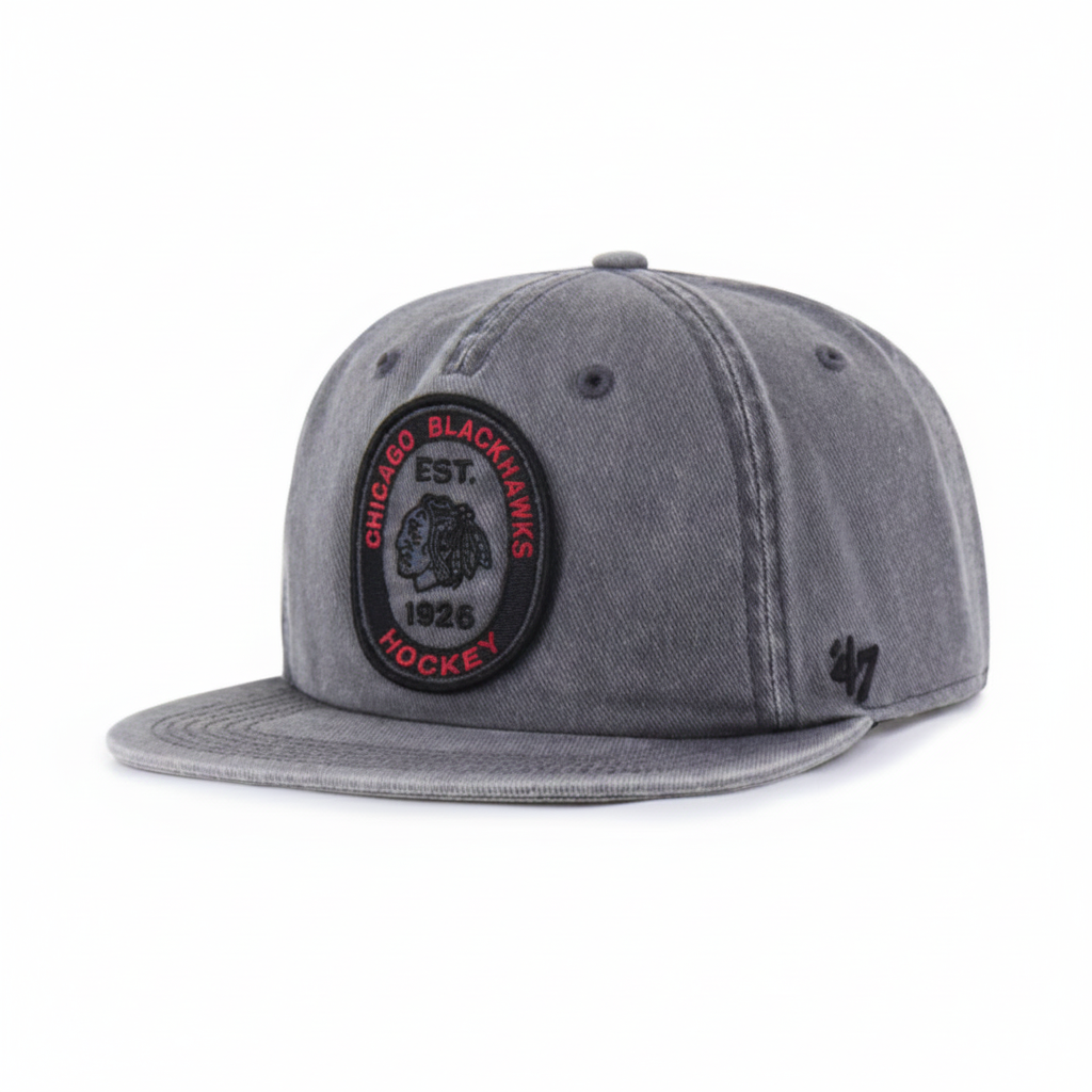 A gray washed snapback cap featuring a circular Chicago Blackhawks embroidered patch on the front and a black '47 logo on the side, set against a plain white background.