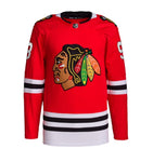 chicago blackhawks red home jersey front of it belongs to conor bedard made by adidas